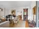 Elegant living room with hardwood floors, grand piano, ornate decor, and dining room view at 171 Westminster Ne Dr, Atlanta, GA 30309