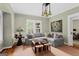 Cozy living room with a gray sectional sofa, hardwood floors, and custom lighting at 171 Westminster Ne Dr, Atlanta, GA 30309
