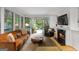 Cozy living room with fireplace and view to backyard garden area at 171 Westminster Ne Dr, Atlanta, GA 30309