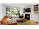 Inviting living room with a fireplace, built-in shelving, and a door leading to a garden at 171 Westminster Ne Dr, Atlanta, GA 30309