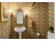 Unique powder room with eye-catching wallpaper and a classic pedestal sink at 171 Westminster Ne Dr, Atlanta, GA 30309