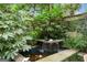 Zen water feature creates a peaceful atmosphere in the lush landscaped backyard at 171 Westminster Ne Dr, Atlanta, GA 30309
