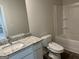 Updated bathroom features modern vanity with granite countertop, toilet and tub/shower combo at 5322 Tolar Rd # 27, South Fulton, GA 30213