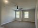 Spacious bedroom with two windows, carpet flooring, and neutral walls at 5322 Tolar Rd # 27, South Fulton, GA 30213