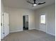 Spacious bedroom showcasing plush carpeting, a ceiling fan, and an ensuite bathroom with a door to outside at 5322 Tolar Rd # 27, South Fulton, GA 30213