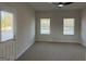 Bright bedroom offering plush carpeting, two windows with blinds, and a door to outside at 5322 Tolar Rd # 27, South Fulton, GA 30213