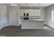 Open-concept kitchen and living area with stainless appliances and modern light fixtures at 5322 Tolar Rd # 27, South Fulton, GA 30213
