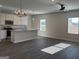 Open-concept kitchen and living area with stainless appliances and modern light fixtures at 5322 Tolar Rd # 27, South Fulton, GA 30213