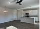 Open-concept kitchen and living area with stainless appliances and modern light fixtures at 5322 Tolar Rd # 27, South Fulton, GA 30213