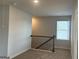Open loft area with carpet, black metal railing, and a window at 5322 Tolar Rd # 27, South Fulton, GA 30213