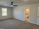 Spacious primary bedroom with carpet flooring, natural light, and ensuite bath at 5322 Tolar Rd # 27, South Fulton, GA 30213