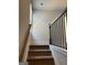 Carpeted stairway with stained wood handrail and black metal balusters leads to the upper level at 5322 Tolar Rd # 27, South Fulton, GA 30213