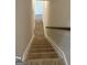 Carpeted stairway with wood handrail leads down, with wood-look floors visible below at 5322 Tolar Rd # 27, South Fulton, GA 30213