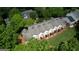 An aerial view showcases the layout of the community with ample green space, multiple units, and surrounding trees at 2160 Dillard Xing, Tucker, GA 30084