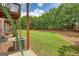 Backyard view with an open grass area near air conditioning units under a wooden deck at 2160 Dillard Xing, Tucker, GA 30084
