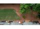 Aerial view of home's backyard featuring a wooded area, a small stream and multiple wooden decks at 2160 Dillard Xing, Tucker, GA 30084