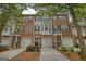 Charming townhouse exteriors featuring brick and siding, attached garages, and lovely landscaping for curb appeal at 2160 Dillard Xing, Tucker, GA 30084