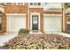 Close-up showing a well-decorated front door with fresh landscaping in front of the attached garage at 2160 Dillard Xing, Tucker, GA 30084