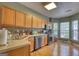 Eat-in kitchen featuring wood floors, stainless steel appliances and an adjacent breakfast nook with many windows at 2160 Dillard Xing, Tucker, GA 30084