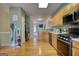 Bright kitchen featuring wood floors and stainless steel appliances and opening to additional living areas at 2160 Dillard Xing, Tucker, GA 30084