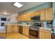 Well-lit eat-in kitchen featuring wood floors, stainless steel appliances, and a tile backsplash at 2160 Dillard Xing, Tucker, GA 30084