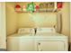 Laundry room featuring a washing machine and dryer as well as overhead storage shelves at 2160 Dillard Xing, Tucker, GA 30084