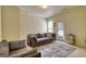 Neutral living room with a comfortable couch, chair and patterned rug near the back door at 2160 Dillard Xing, Tucker, GA 30084