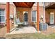 Outdoor patio with hanging swing chair near A/C unit and back door at 2160 Dillard Xing, Tucker, GA 30084