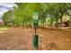 Designated pet area with pet waste station, surrounded by trees at 2160 Dillard Xing, Tucker, GA 30084