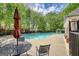 Community pool features lounge chairs, a gazebo and black metal tables and umbrellas at 2160 Dillard Xing, Tucker, GA 30084