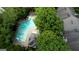 Aerial view of a community pool surrounded by trees and buildings at 2160 Dillard Xing, Tucker, GA 30084