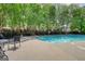 Community pool featuring plenty of seating surrounded by lush green trees at 2160 Dillard Xing, Tucker, GA 30084