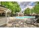 A community pool area provides a serene retreat surrounded by lush greenery and comfortable lounge chairs at 2160 Dillard Xing, Tucker, GA 30084