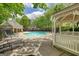 Community pool with a gazebo, black metal seating, and surrounded by mature trees and greenery at 2160 Dillard Xing, Tucker, GA 30084