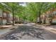 Charming street view of brick townhomes with mature trees lining the street, creating a welcoming atmosphere at 2160 Dillard Xing, Tucker, GA 30084