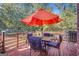 Back deck with outdoor dining furniture and an umbrella at 7523 Kimberly Lynn Ct, Lithonia, GA 30058