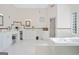 Bright bathroom featuring double vanity, soaking tub, and glass block window at 7523 Kimberly Lynn Ct, Lithonia, GA 30058