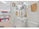 Bright bathroom featuring a white vanity, framed mirror, and neutral color palette at 7523 Kimberly Lynn Ct, Lithonia, GA 30058
