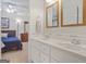 Bathroom with double sinks, ceiling fan and access to main bedroom at 7523 Kimberly Lynn Ct, Lithonia, GA 30058