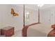 Bedroom featuring a four-poster bed, ceiling fan, and a hallway leading to a bathroom at 7523 Kimberly Lynn Ct, Lithonia, GA 30058