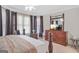 Bedroom with neutral carpeting, ensuite bathroom, and bay window with curtains at 7523 Kimberly Lynn Ct, Lithonia, GA 30058