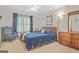 Bedroom featuring an upholstered chair, a ceiling fan, and a wooden dresser at 7523 Kimberly Lynn Ct, Lithonia, GA 30058
