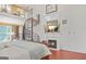 Grand bedroom featuring a fireplace, spiral staircase, and loft area at 7523 Kimberly Lynn Ct, Lithonia, GA 30058