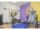 Vibrant exercise room with equipment and colorful walls, perfect for a home gym setup at 7523 Kimberly Lynn Ct, Lithonia, GA 30058