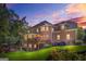A multi-story brick home with a wooden deck, well-maintained lawn, and landscaped garden at 7523 Kimberly Lynn Ct, Lithonia, GA 30058
