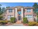 Elegant brick home featuring a stately front entrance with pillars and a beautiful arched window at 7523 Kimberly Lynn Ct, Lithonia, GA 30058