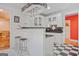 Charming kitchen with black countertops, white cabinets, and checkered floors at 7523 Kimberly Lynn Ct, Lithonia, GA 30058