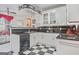 Stylish kitchen featuring black and white checkered floors and unique overhead lighting at 7523 Kimberly Lynn Ct, Lithonia, GA 30058