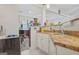 Convenient kitchenette area with granite countertops, white cabinetry, and stainless sink at 7523 Kimberly Lynn Ct, Lithonia, GA 30058