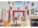 Sun-drenched living room featuring a fireplace, hardwood floors, and expansive windows with stylish drapery at 7523 Kimberly Lynn Ct, Lithonia, GA 30058